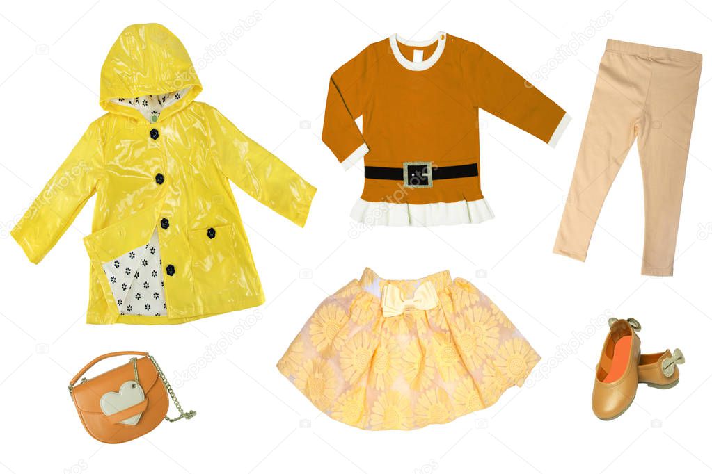 Summer fashion. Collage set of baby child girl clothes isolated on a white background. T-shirts, skirts, shoes or sneaker and rain jacket.