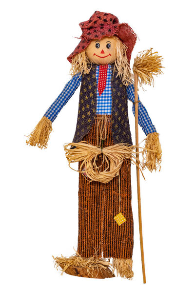 Straw decorations background. Close-up of a funny handmade scarecrow doll isolated on white background. Straw dolls for thanksgiving in autumn. Macro.