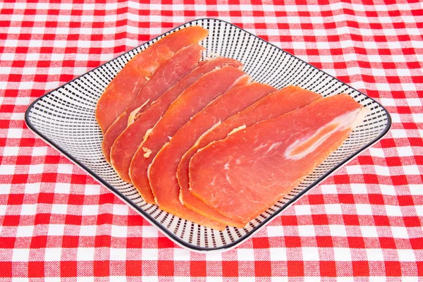 Spanish food. Closeup of pieces of sliced dry spanish ham (Jamon