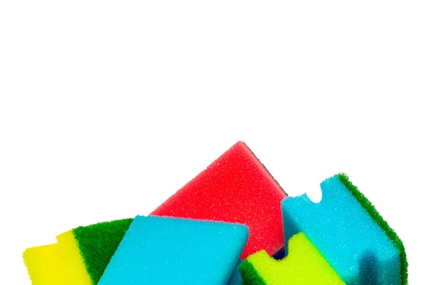 Close-up of a stack or heap of various colorful sponges or scouring pads isolated on a white background. Household chore concept. Top view. — Stock Photo, Image