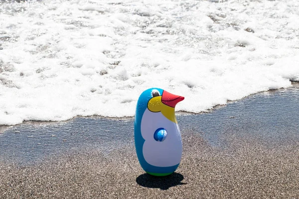 Beach toy background. Selective focus on one colorful inflatable