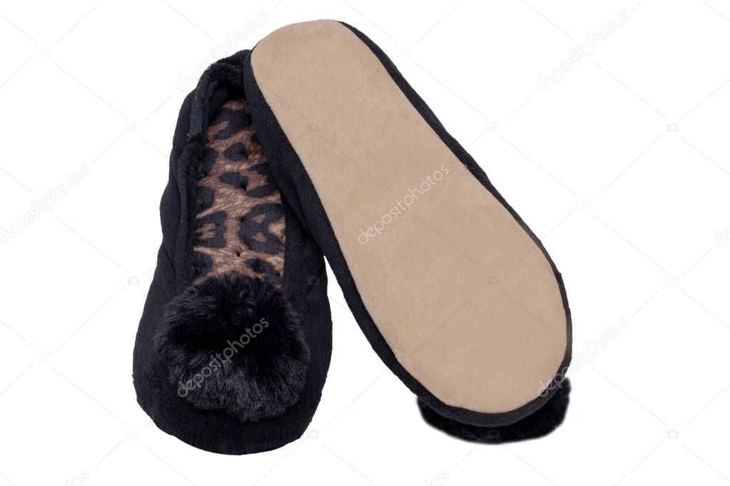 Slippers isolated. Close-up of a pair of black female house slippers isolated on a white background. Woman shoes.