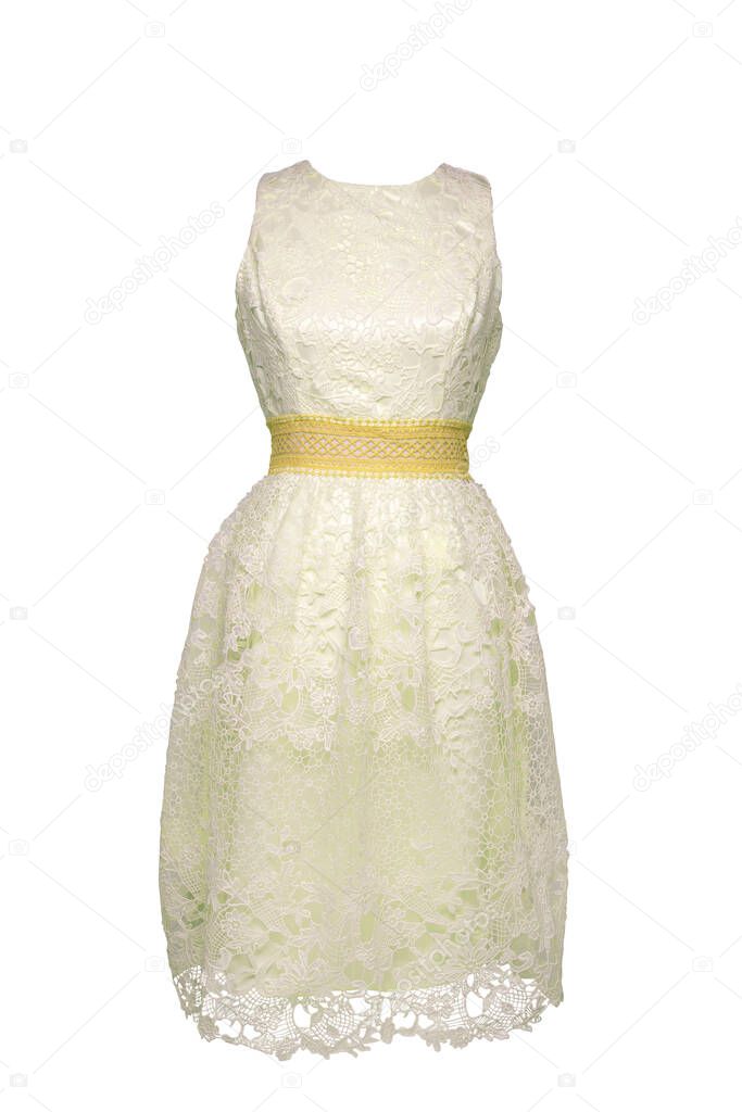 Lacy dress isolated. Closeup of a white yellow stylish sleeveless evening dress with lace on mannequin isolated on a white background. Summer fashion.