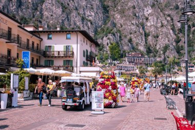 Limone, Italy, Lombardy, 28 April 2025. Tourists near the harbour of Limone sul Garda stroll through the idyllic streets. Famous destination on Lake Garda.