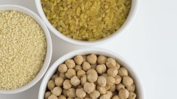 Three bowls of couscous, burgul and chickpeas. — Stock Video