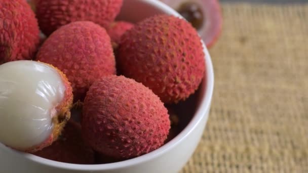 Roterande färsk Litchi i vit skål. — Stockvideo