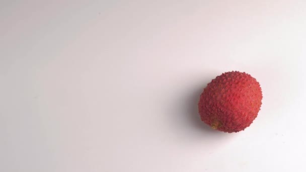 One lychee rotates on a white background — Stock Video