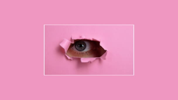 분홍색 종이 구멍 속을 들여다보고 있는 여자들의 눈. — 비디오