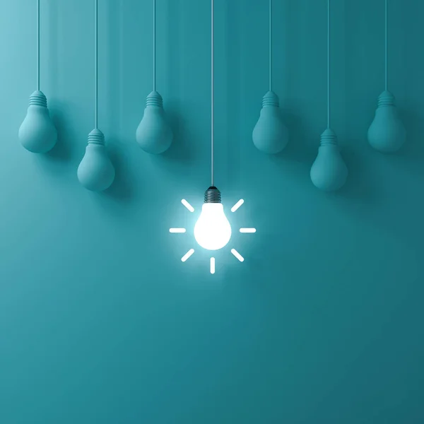 Think different concept One hanging glowing idea light bulb standing out from dim unlit bulbs on green pastel color wall background leadership and individuality creative idea concepts 3D rendering