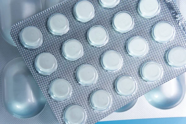 Pills in pack on blue background