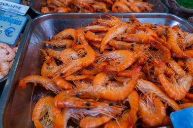 Bir sokak pazarında bir tavada Karides