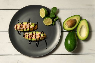 Beyaz ahşap arka planda karides, avokado ve limonlu bruschetta.