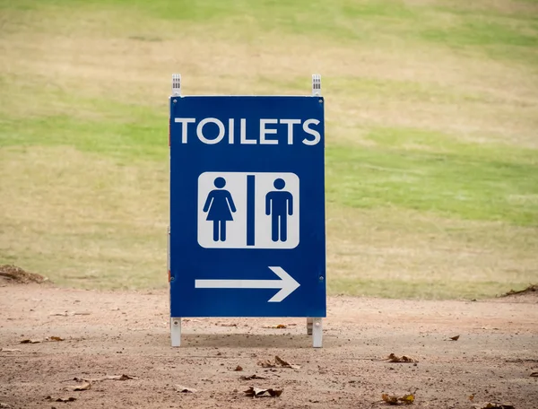 Temporary sign TOILETS with arrow and symbol of man and woman in