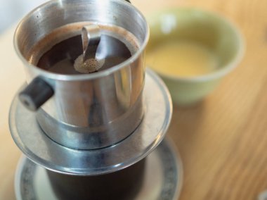 Geleneksel Vietnam filtre kahve ile sabah ahşap masa üstünde yoğunlaştırılmış süt