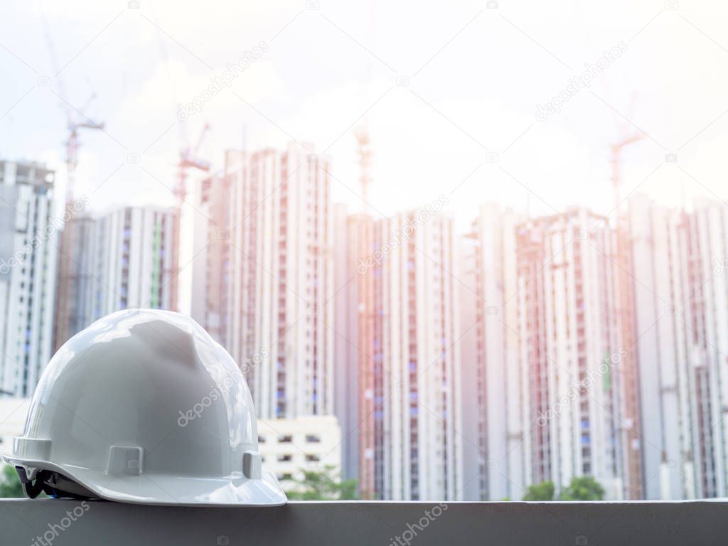 White hard safety helmet for civil engineer, protect and safety hat for engineering worker on construction building site background.