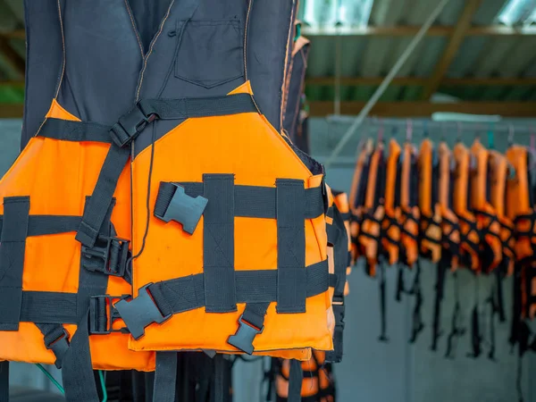 Life jackets safety equipment hanging on the bars for the tourism service.