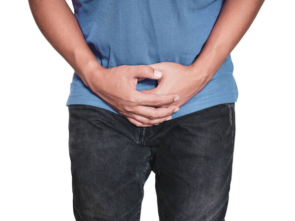 Man hands holding on middle crotch of trousers with pain action isolated on white background.