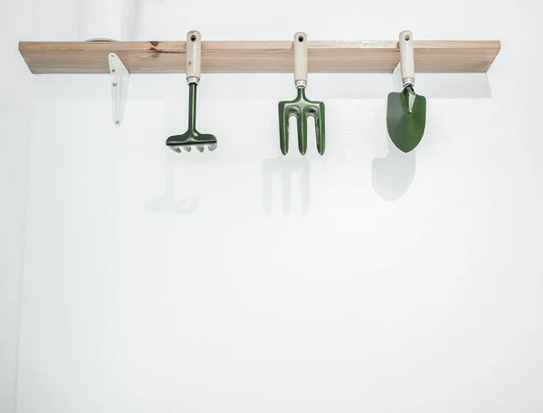 Green Gardening Tools Hanging Wooden Rack White Wall Background Copy — Stock Photo, Image