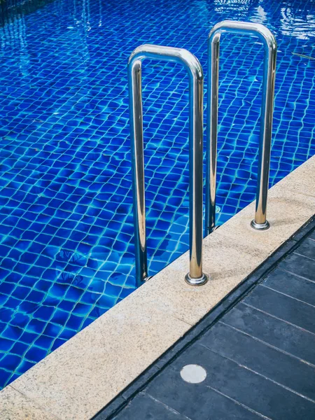 Grab bars ladder in swimming pool vertical style. Swimming pool stairs.