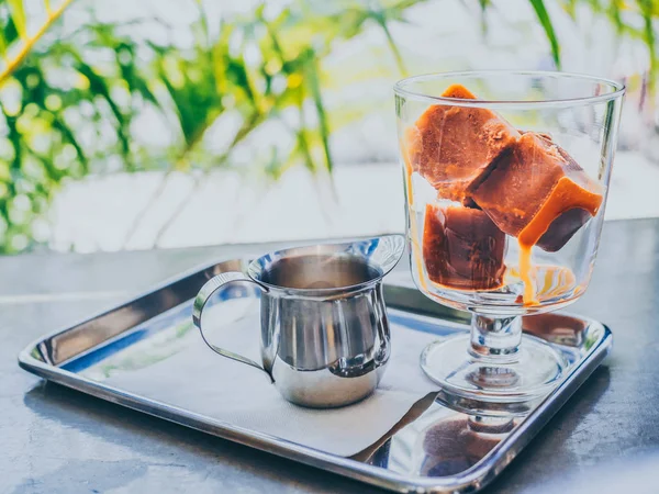 Thai milk tea ice cubes in glass