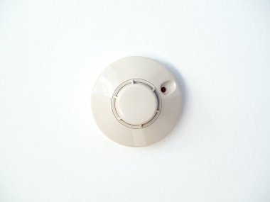 Smoke detector on white ceiling