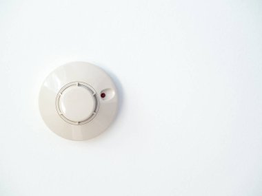 Smoke detector on white ceiling