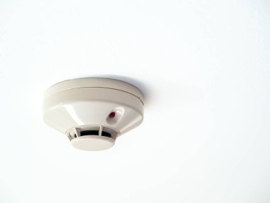 Smoke detector on white ceiling