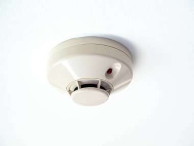 Smoke detector on white ceiling