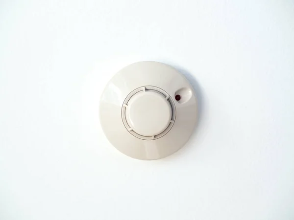 Smoke detector on white ceiling — 스톡 사진
