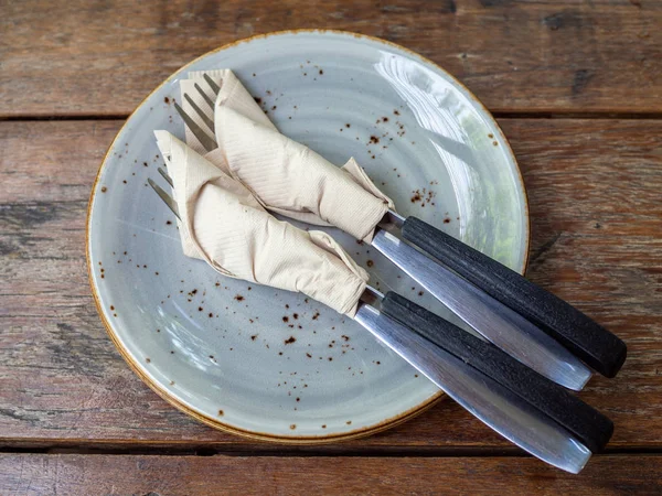 Two set of clean fork and knife wrapped in tissue napkin in the — Stock Photo, Image