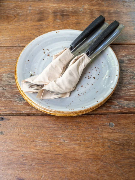 Two set of clean fork and knife wrapped in tissue napkin in the — Stock Photo, Image