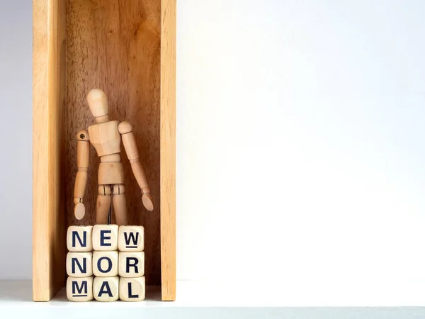 New Normal, Wooden figure and words on wooden alphabet cube inside box with copy space. New normal after covid-19 pandemic concept.