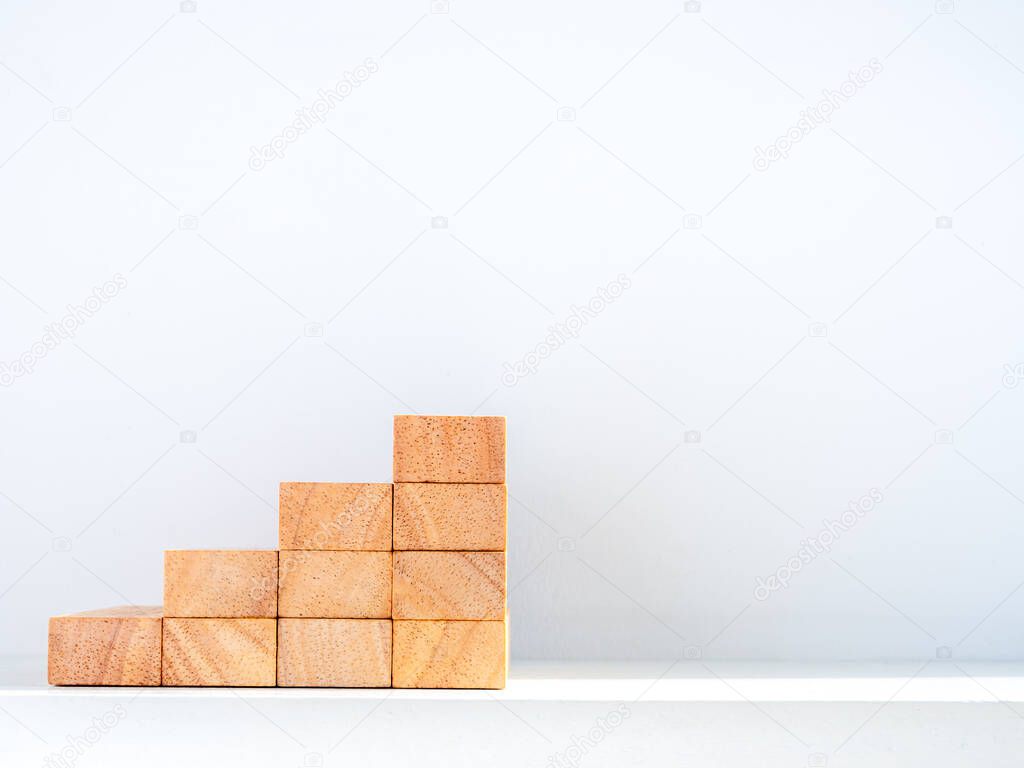 Wooden stairs miniature on white background with copy space, way to success concept.