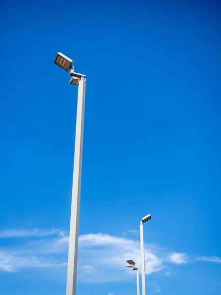 LED street lighting pole. Modern street lights on blue sky background, vertical style.