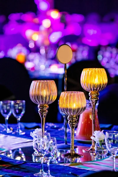 Table setting with candles at gala dinner.