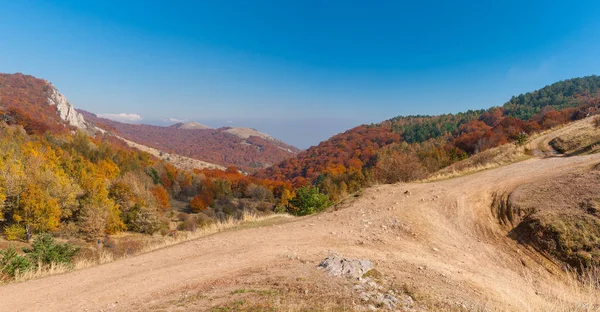 Autumnal landscape with earth road in mountain pasture Demerdzhi, Crimean peninsula