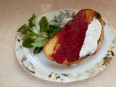 Ahududu püresi ve yoğurt ile kaplı tost ile bir tabak üzerinde üst görünümü 
