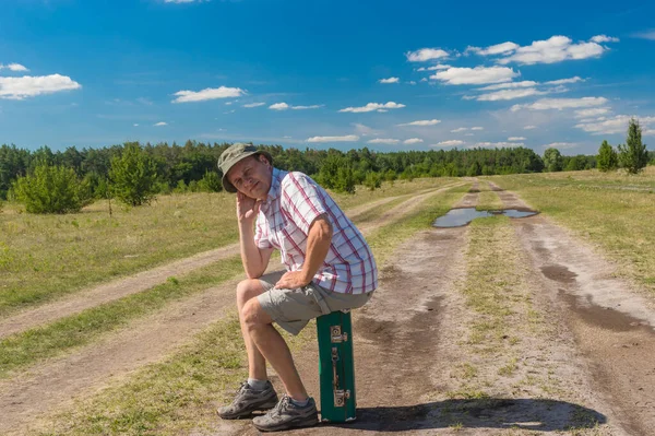 Portrait Mature Caucasian Man Sitting Old Green Suitcase While Hiking Royalty Free Stock Images