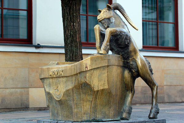 Lublin, Poland - April 30, 2018: Street fountain with the sculpture of bronze goat - the mascot of the Lublin City, attribute of the goddess Venus and the symbol of fertility.