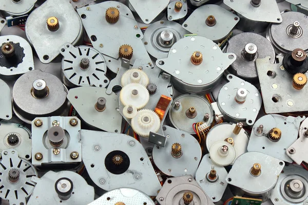 Pile of old stepper motors. Electronics industry e-waste background