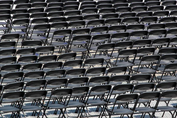 Multiple chairs outdoor, many black chair backs — Stock Photo, Image