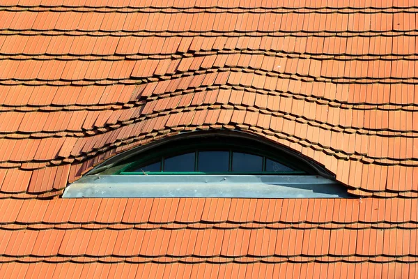 Vista detallada de un techo rojo tradicional, con pequeñas ventanas con forma de ojo —  Fotos de Stock