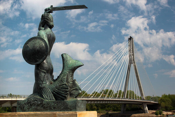 Mermaid (Syrenka) statue, the famous symbol of the city, on Vistula River embankment. Warsaw, Poland.