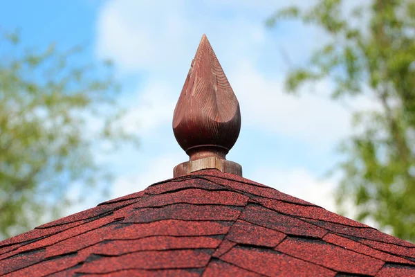 Asphalt shingle and wooden spire on a gazebo roof