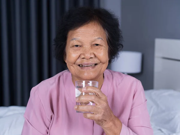 Senior Woman Drinking Water Bedroom — Stock Photo, Image