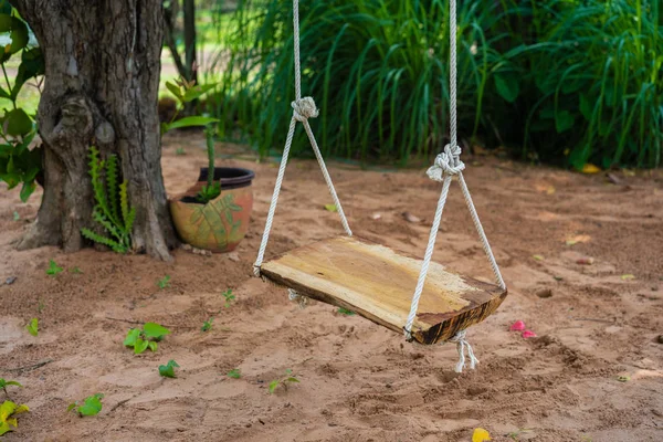 wooden swing in the garden
