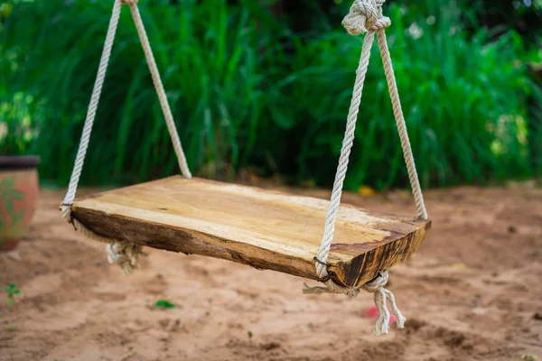 wooden swing in the garden