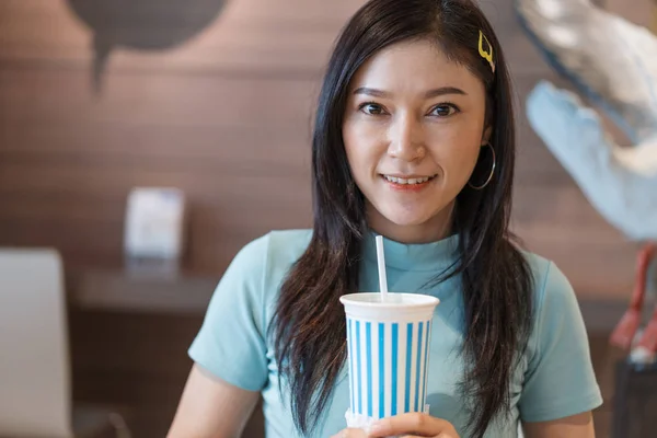 woman are drinking water by suction tube.