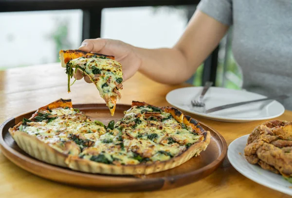 Hand Grabbing Piece Spinach Goat Cheese Pizza Wooden Table — Stock Photo, Image