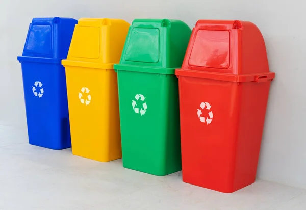 four colorful recycle bins on the floor